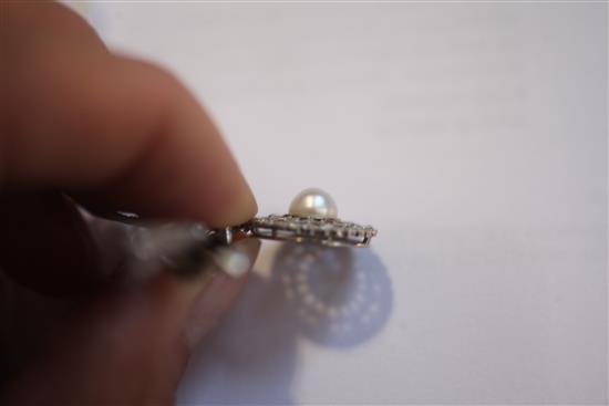 A Belle Epoque platinum and gold, diamond and split pearl set bow brooch with openwork target drop, width 2in.